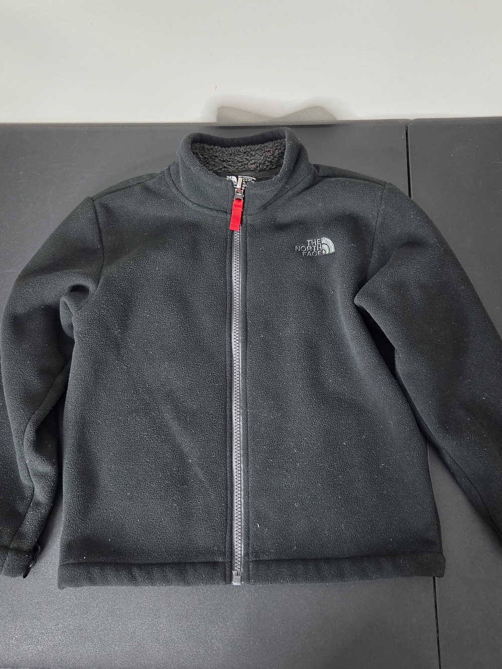 The North Face Kids Black Fleece Jacket with Red Zipper Pull